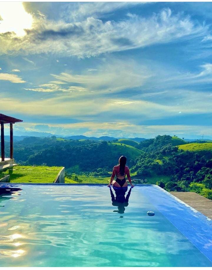This image depicts a minimalist arrangement of ceramic teaware, including a teapot, sugar bowl, creamer, and teacup on a l...
